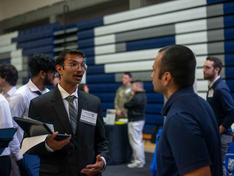 Student talking to employeer at career fair 